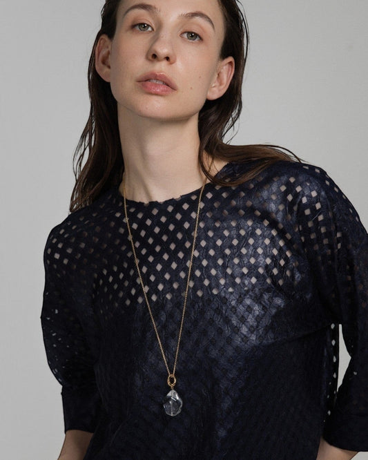 Model wearing an Elsita Jewelry Lustre II clear quartz pendant necklace on a gold-toned stainless steel chain.