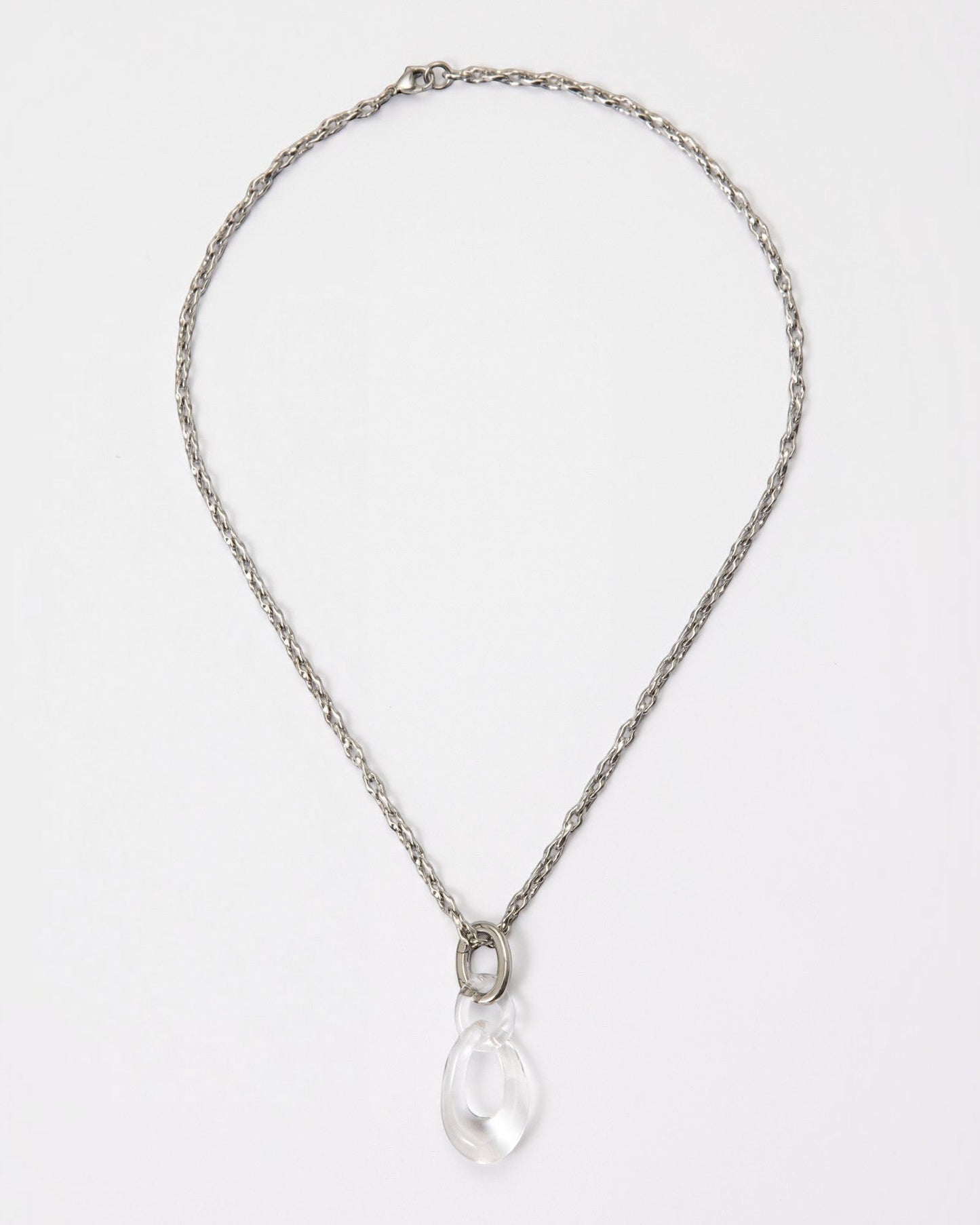 Elsita Jewelry Link Clear necklace featuring a hand-carved clear quartz interlocked chain pendant on a silver-tone chain.