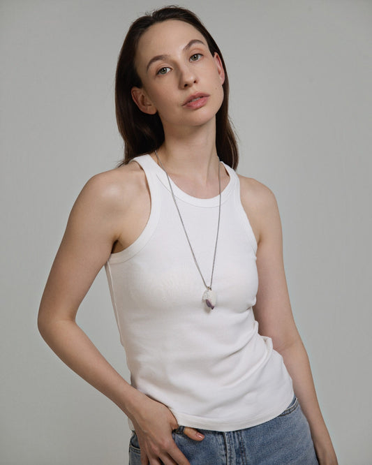 Model wearing an Elsita Jewelry Hyacinth Jasper and clear quartz pendant necklace on a stainless steel chain.