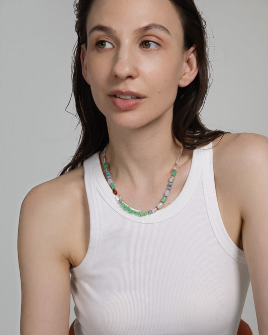 Elsita Jewelry Spring necklace featuring multi-colored chrysoprase, pearl, and mineral beads on a model.