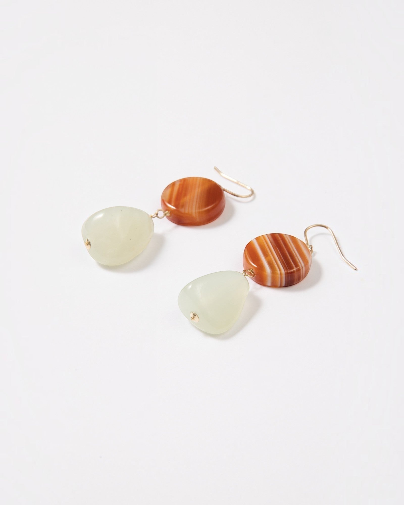 Elsita Jewelry Dawn earrings featuring round red banded agate and triangular Xiuyan jade on 14K gold-filled hooks.