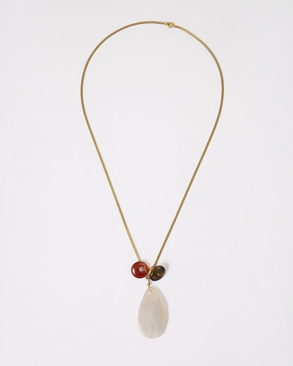 Elsita Jewelry Glacier Day necklace featuring a white agate slice, red agate ring, and smoky quartz on a gold chain.