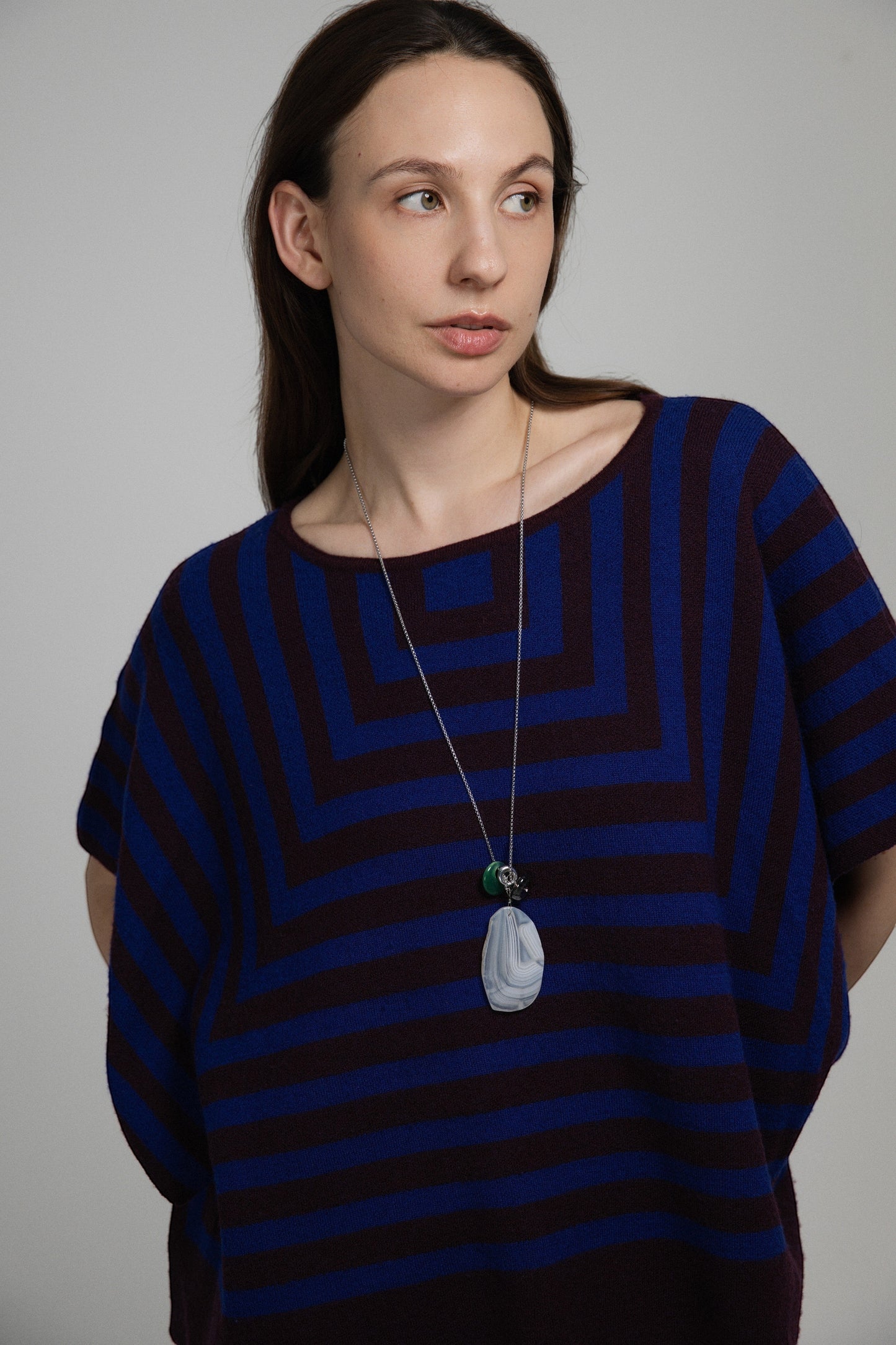 Model wearing an Elsita Jewelry Glacier Night necklace featuring white agate, green agate, and smoky quartz on a chain.