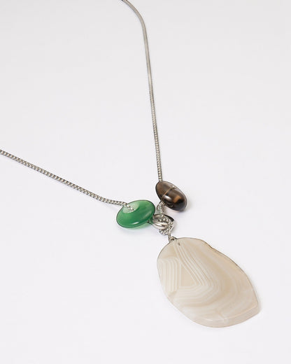 Elsita Jewelry Glacier Night necklace featuring a white agate pendant, green agate, and smoky quartz on a silver chain.