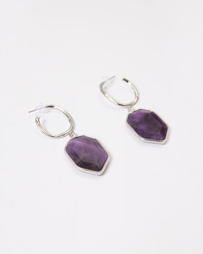 Elsita Jewelry Calm amethyst earrings featuring geometric violet stones on sterling silver hoops against white background