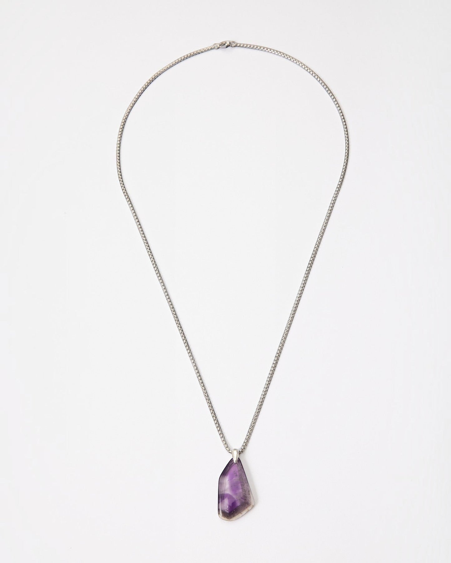 Elsita Jewelry Kaleidoscope III amethyst pendant necklace with a raw purple crystal stone on a sterling silver chain.