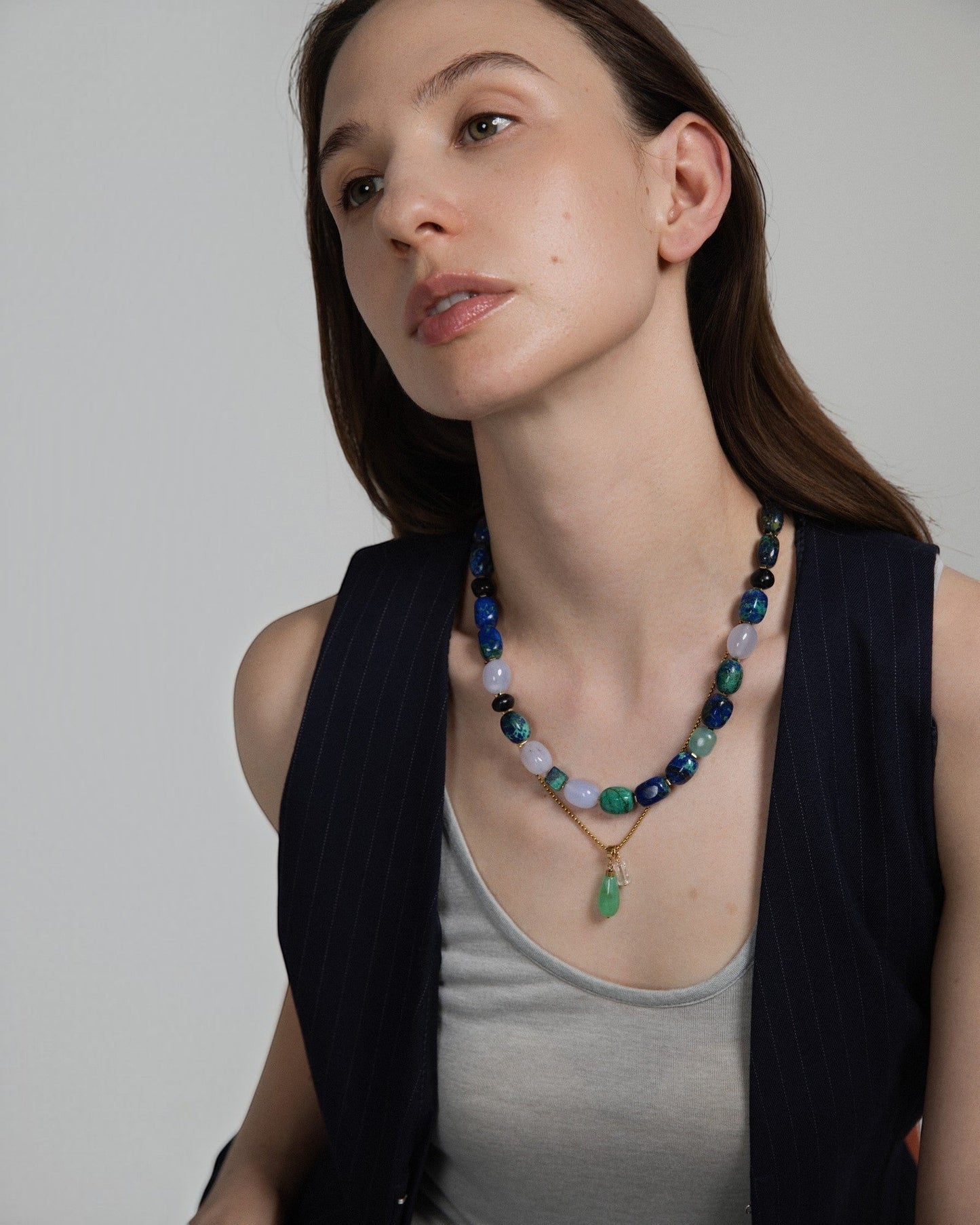 Model wearing Elsita Jewelry Bamboo necklace featuring a green chrysoprase teardrop pendant and clear quartz beads.