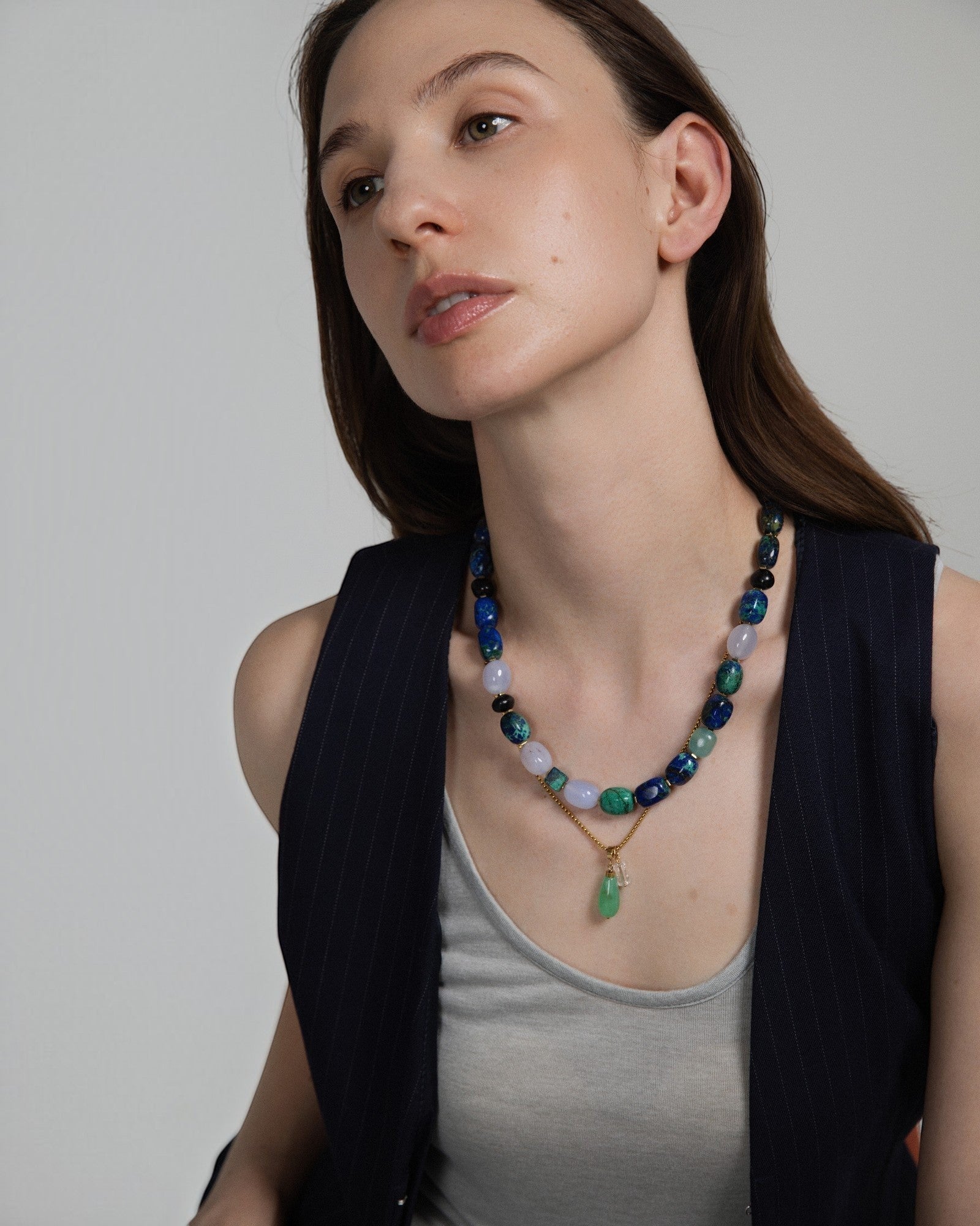 Model wearing Elsita Jewelry Bamboo necklace featuring a green chrysoprase teardrop pendant and clear quartz beads.