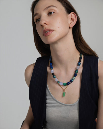 Model wearing Elsita Jewelry Bamboo necklace featuring a green chrysoprase teardrop pendant and clear quartz beads.