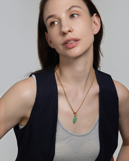 Elsita Jewelry Bamboo necklace featuring a green teardrop chrysoprase and segmented clear quartz on a gold chain.