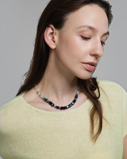 Elsita Jewelry Blausee Deep necklace featuring faceted black agate, chrysocolla, and chalcedony beads on a model.