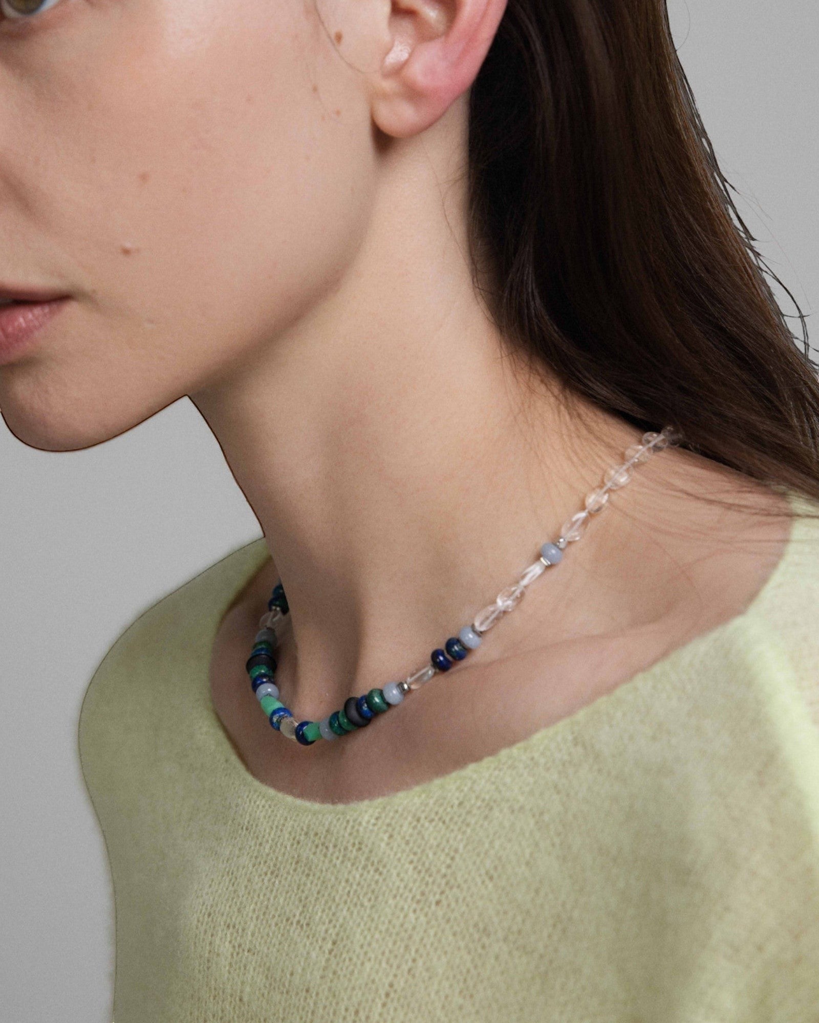Model wearing Elsita Jewelry Blausee Light necklace featuring chrysocolla, chrysoprase, and clear quartz beads.