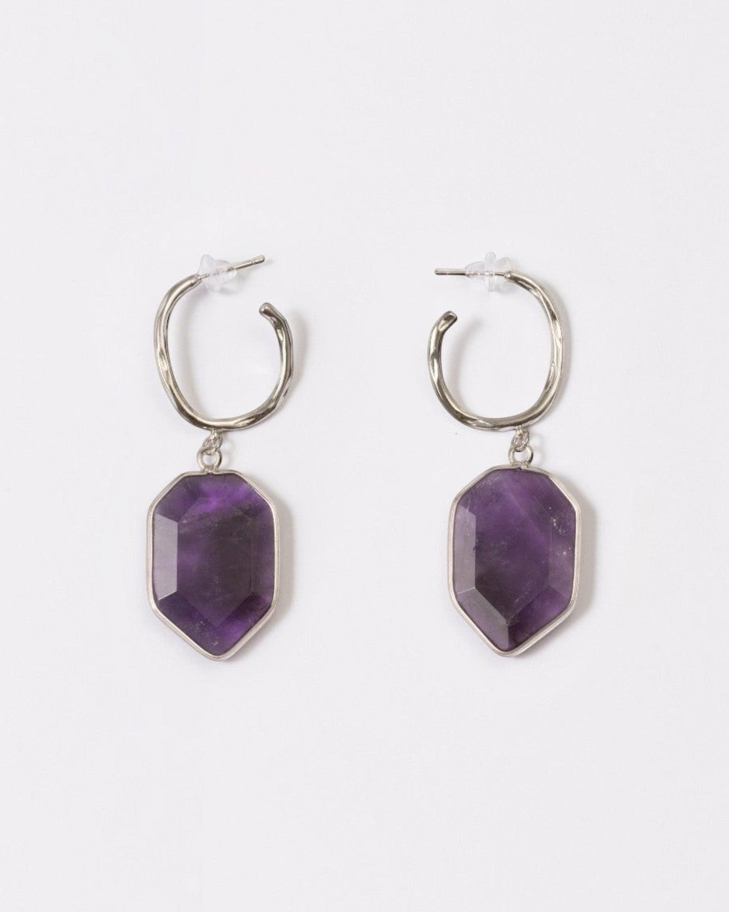 Elsita Jewelry Calm amethyst earrings featuring geometric deep violet stones on silver hoops against a white background.