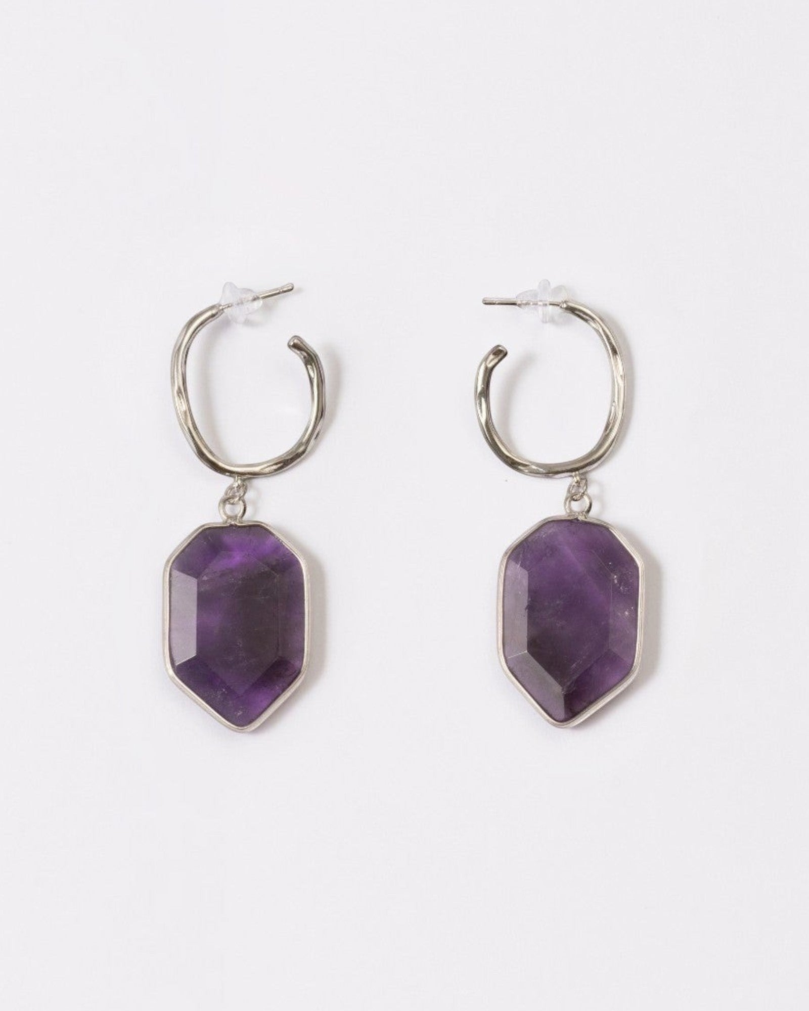 Elsita Jewelry Calm amethyst earrings featuring geometric deep violet stones on silver hoops against a white background.