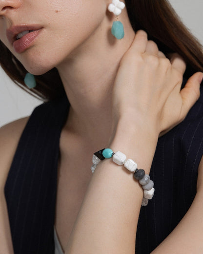 Elsita Jewelry Chill bracelet featuring turquoise, howlite, and mixed mineral beads on a woman wearing matching earrings