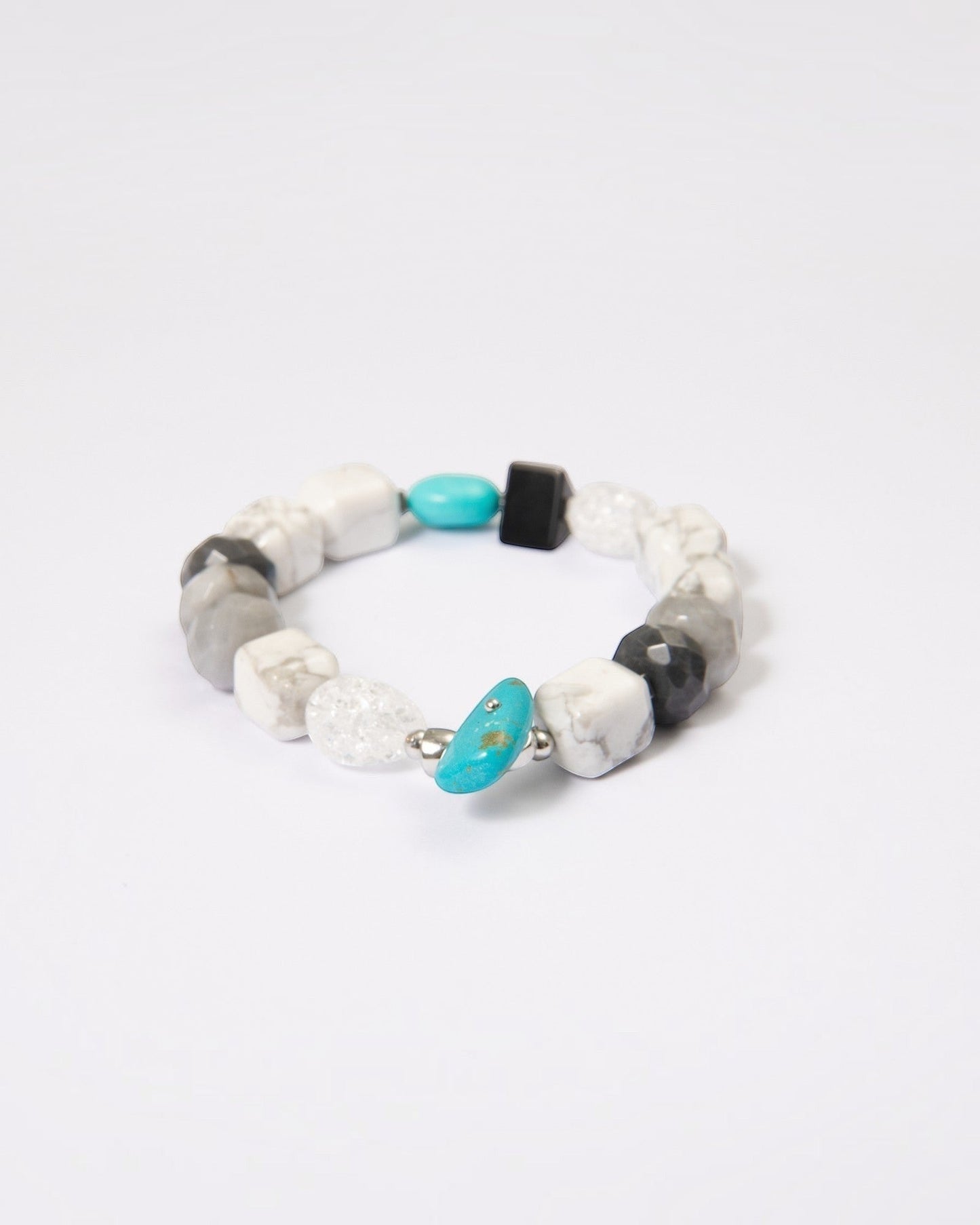 Elsita Jewelry Chill bracelet featuring turquoise, howlite, black agate, clear quartz, and hawk's eye mineral beads.