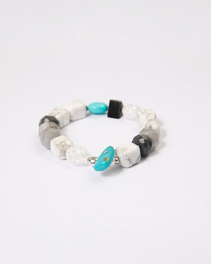 Elsita Jewelry Chill bracelet featuring turquoise, howlite, black agate, clear quartz, and hawk's eye mineral beads.
