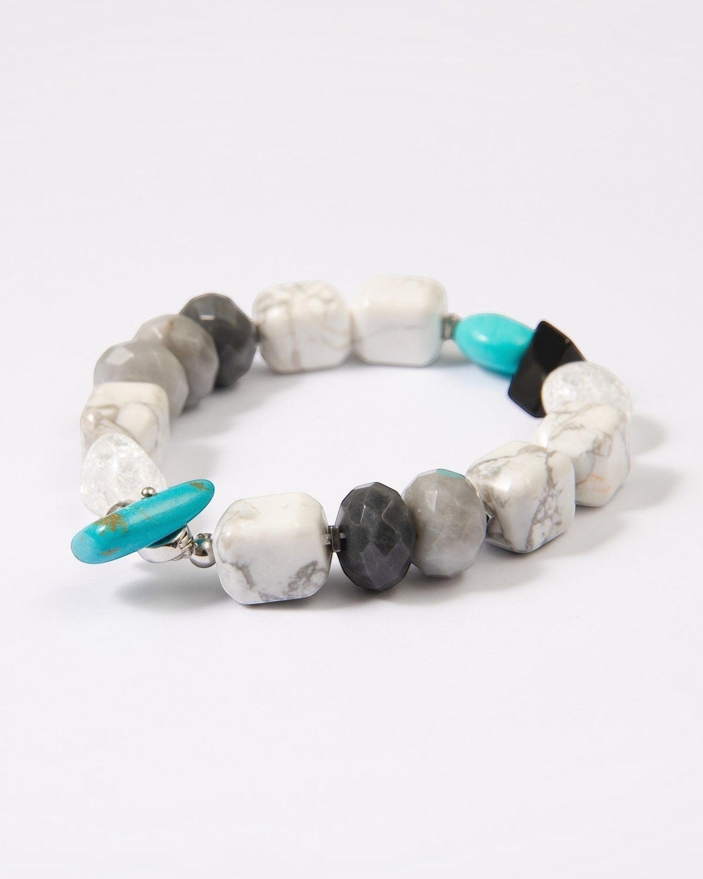 Elsita Jewelry Chill bracelet featuring turquoise, howlite, black agate, clear quartz, and hawk's eye mineral beads.