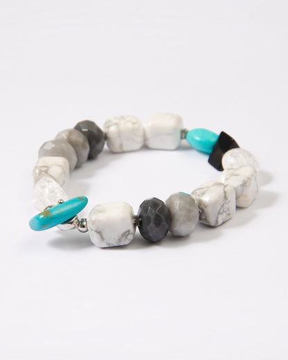 Elsita Jewelry Chill bracelet featuring turquoise, howlite, black agate, clear quartz, and hawk's eye mineral beads.