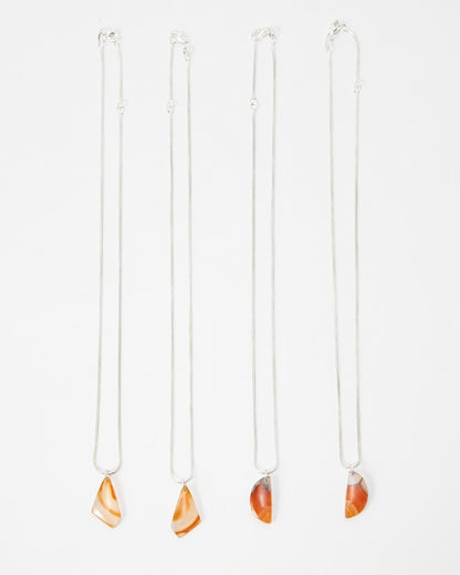 Elsita Jewelry Citrus II necklaces featuring polished orange and red agate pendants on delicate silver chains