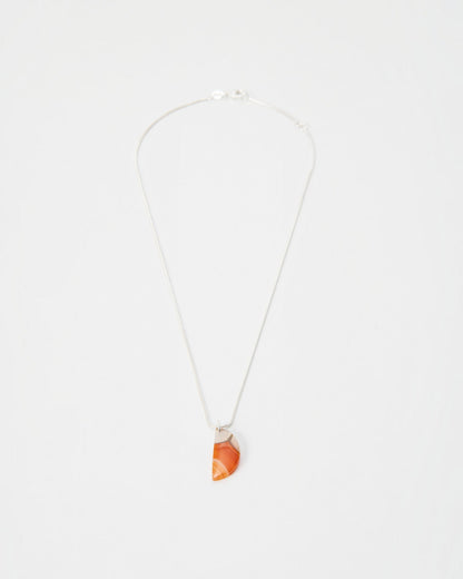 Elsita Jewelry Citrus I necklace featuring a semi-circular orange agate pendant on a delicate silver chain