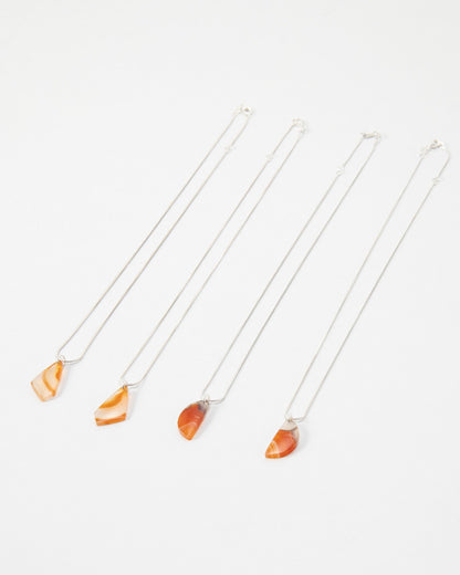 Elsita Jewelry Citrus I necklaces featuring orange and red banded agate stone pendants on delicate silver chains.