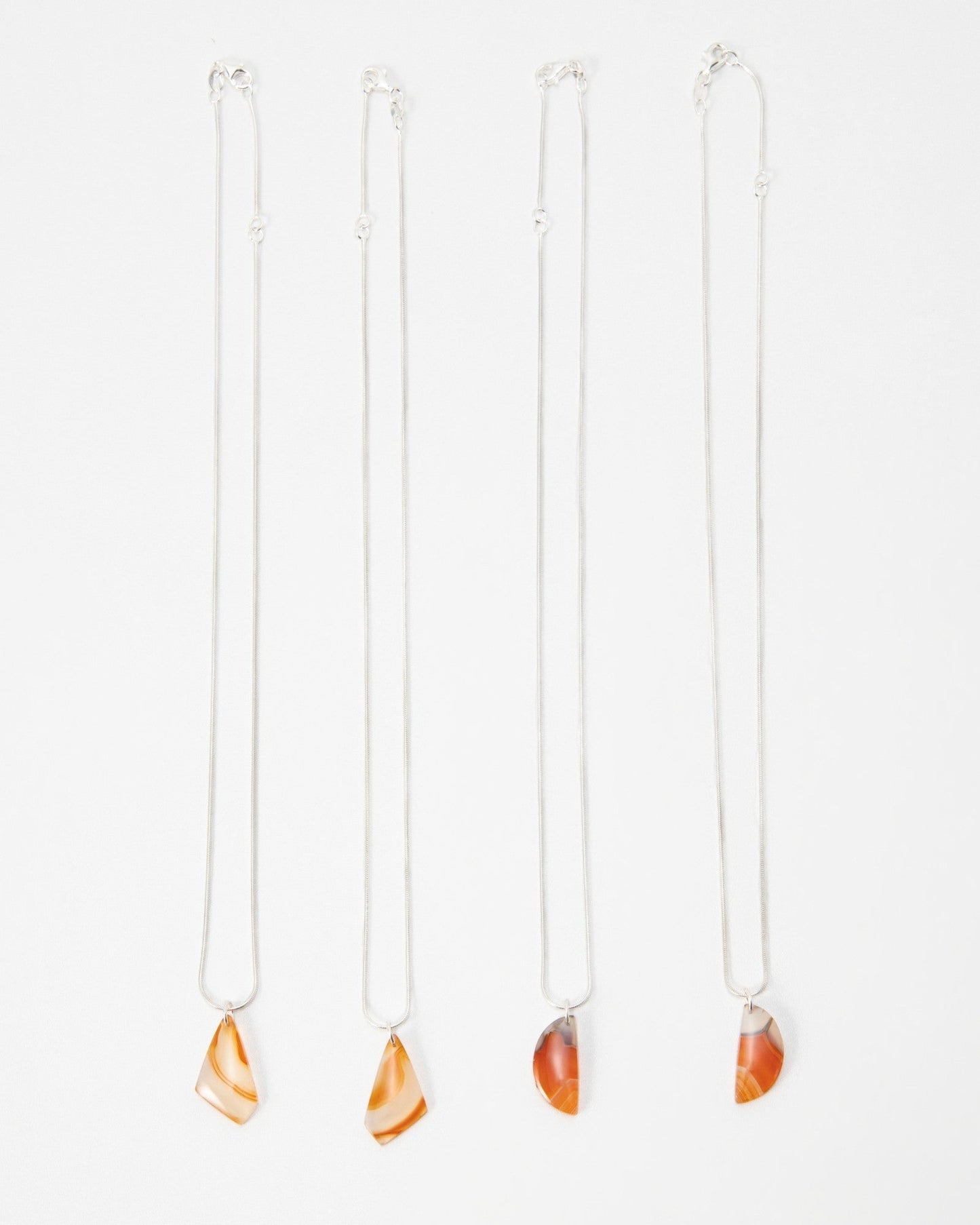 Elsita Jewelry Citrus I necklaces featuring orange agate stone pendants on delicate silver chains