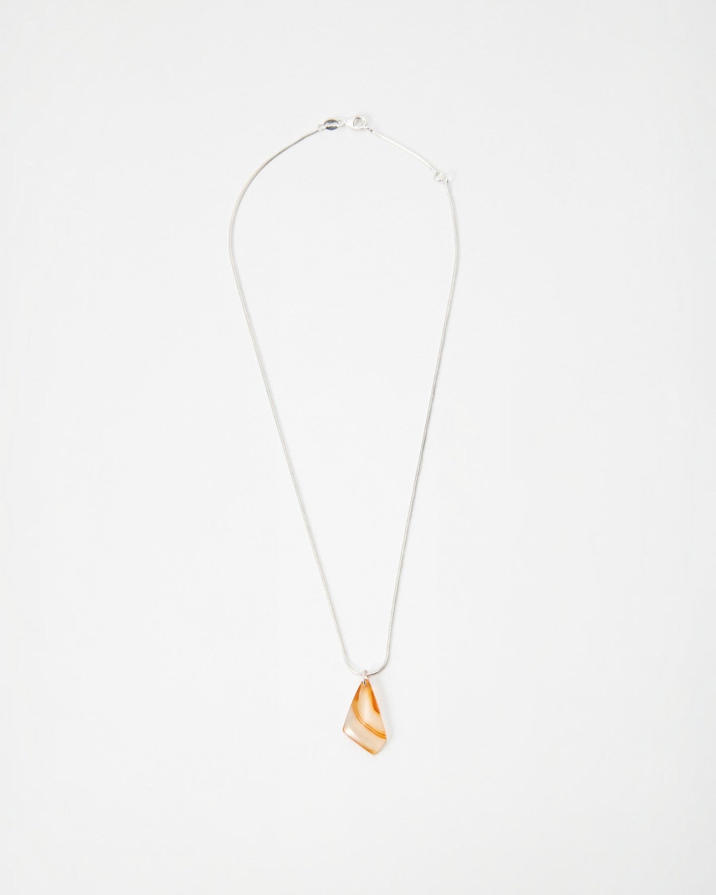 Elsita Jewelry Citrus II necklace featuring a translucent orange and white agate pendant on a delicate silver chain