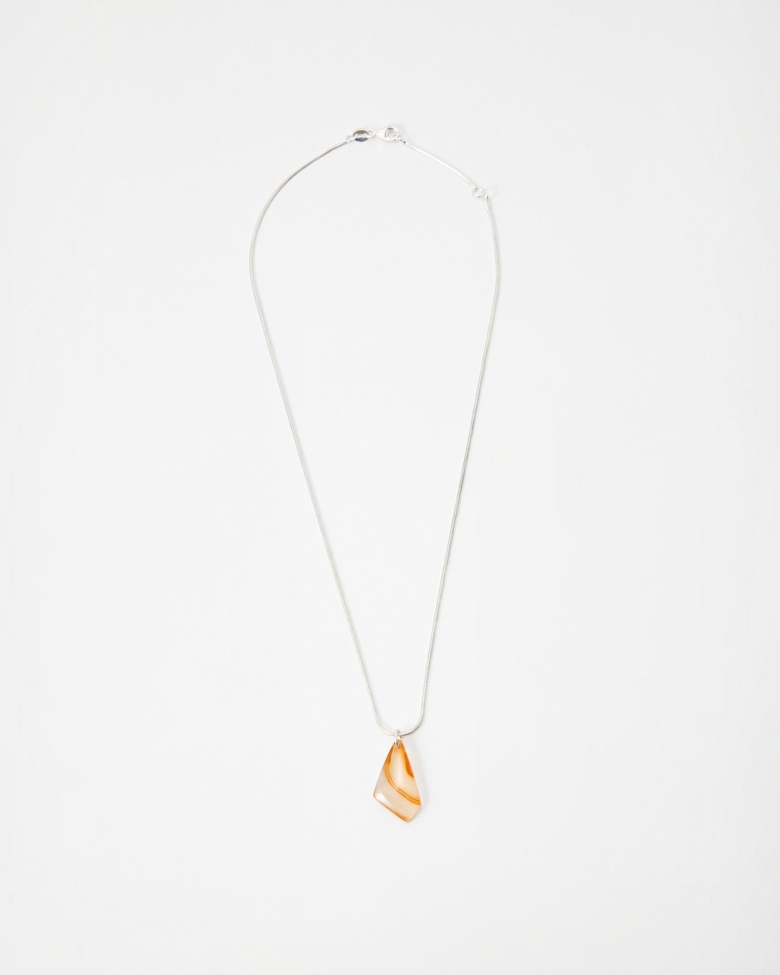 Elsita Jewelry Citrus II necklace featuring a translucent orange and white agate pendant on a delicate silver chain
