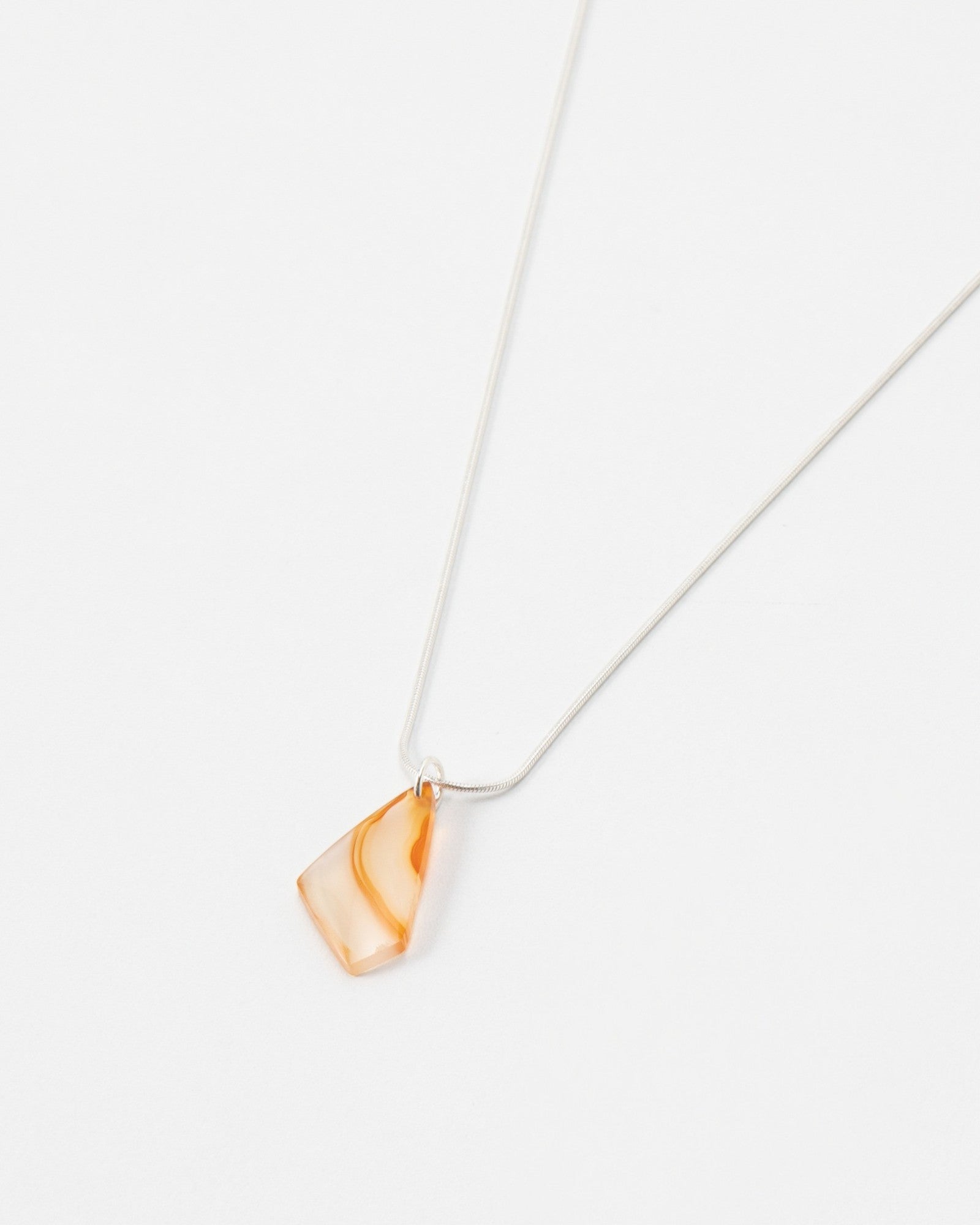Elsita Jewelry Citrus II necklace featuring a translucent orange gemstone pendant on a delicate silver chain