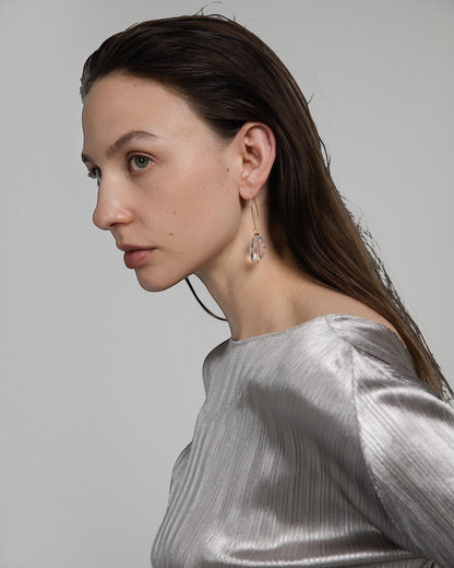 Model wearing Elsita Jewelry faceted clear quartz drop earrings with 14K gold-filled hooks and stainless steel beads.