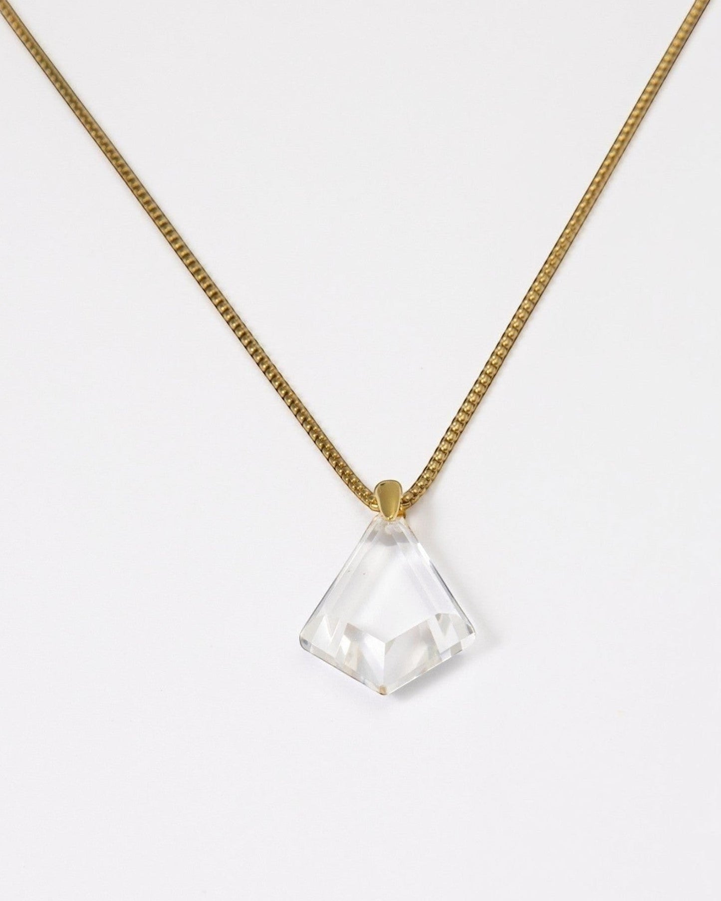 Elsita Jewelry Lustre III necklace featuring a clear quartz pendant on a gold-toned stainless steel chain.