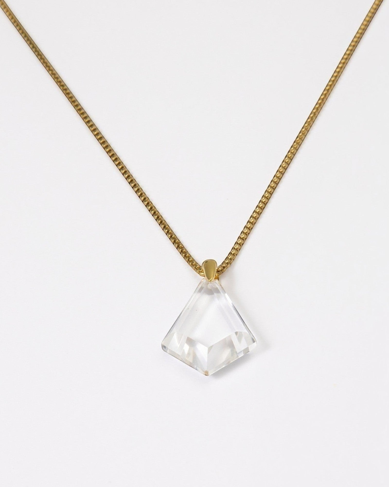 Elsita Jewelry Lustre III necklace featuring a clear quartz pendant on a gold-toned stainless steel chain.