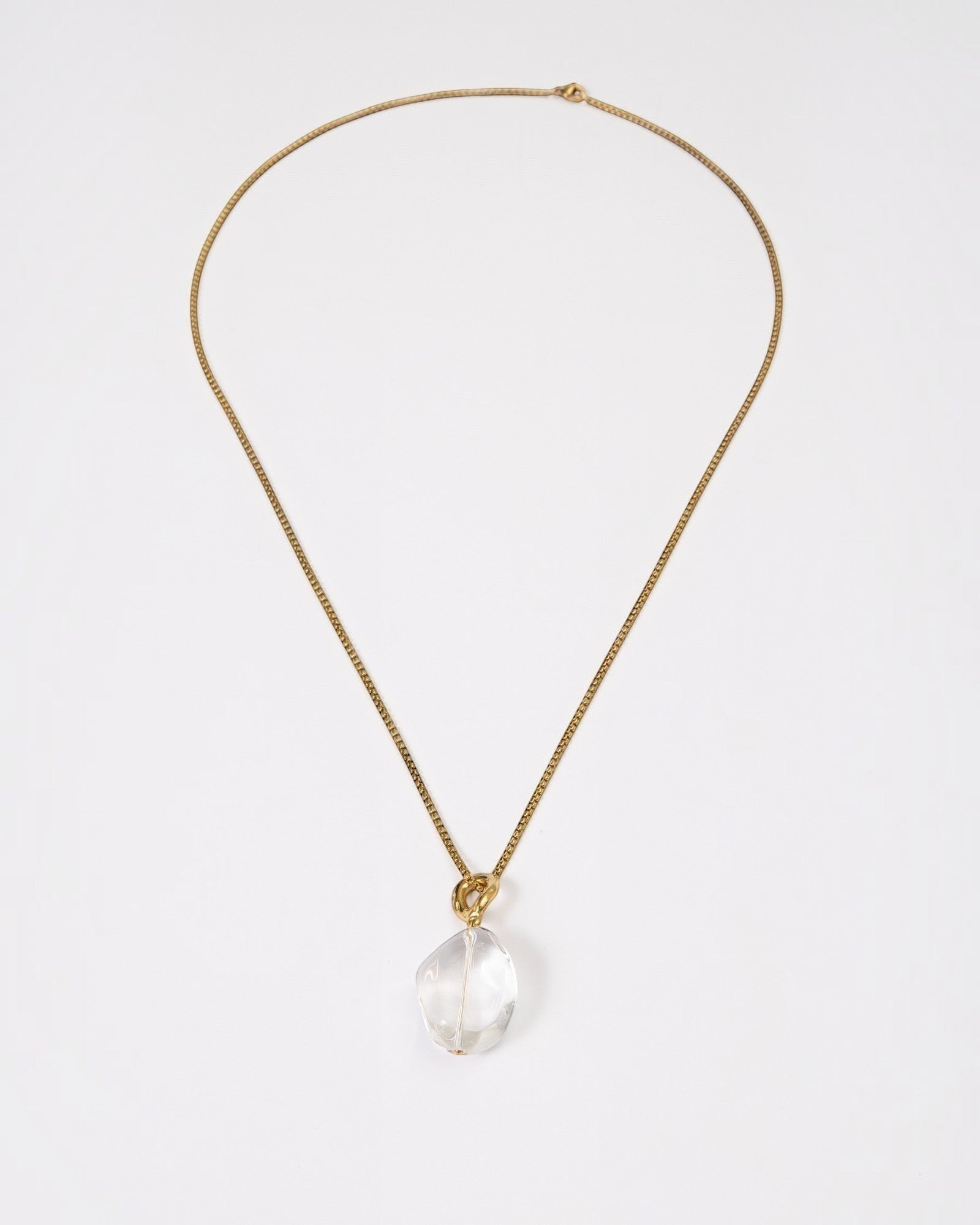 Elsita Jewelry Lustre II necklace featuring a clear quartz pendant on a delicate gold-tone stainless steel chain.
