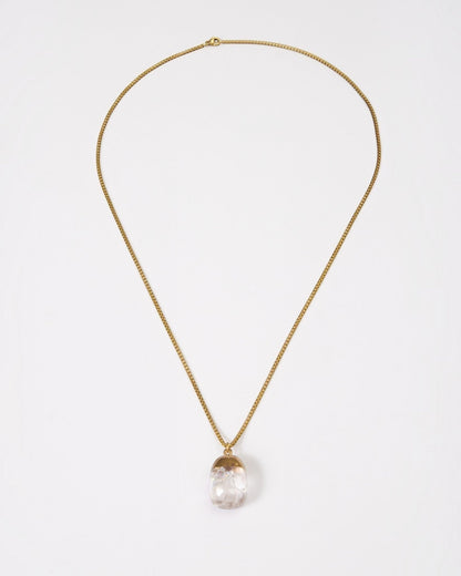 Elsita Jewelry Lustre IV necklace featuring a clear quartz pendant on a gold-toned stainless steel chain.
