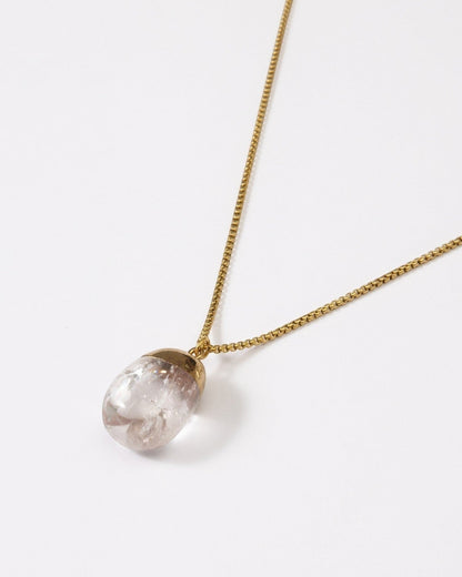 Elsita Jewelry Lustre IV necklace featuring a clear quartz pendant with gold-tone stainless steel on a delicate chain.
