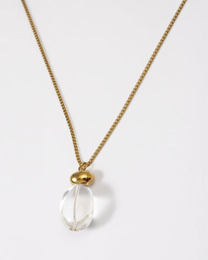 Elsita Jewelry Lustre I necklace featuring a clear quartz pendant on a polished gold-tone stainless steel chain.