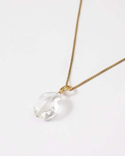 Elsita Jewelry Lustre II necklace featuring a clear quartz pendant on a delicate gold-tone stainless steel chain.