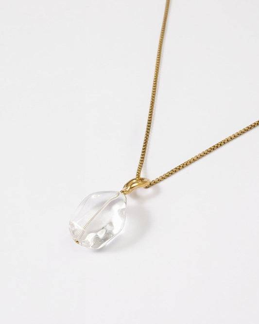 Elsita Jewelry Lustre II necklace featuring a clear quartz pendant on a delicate gold-tone stainless steel chain.