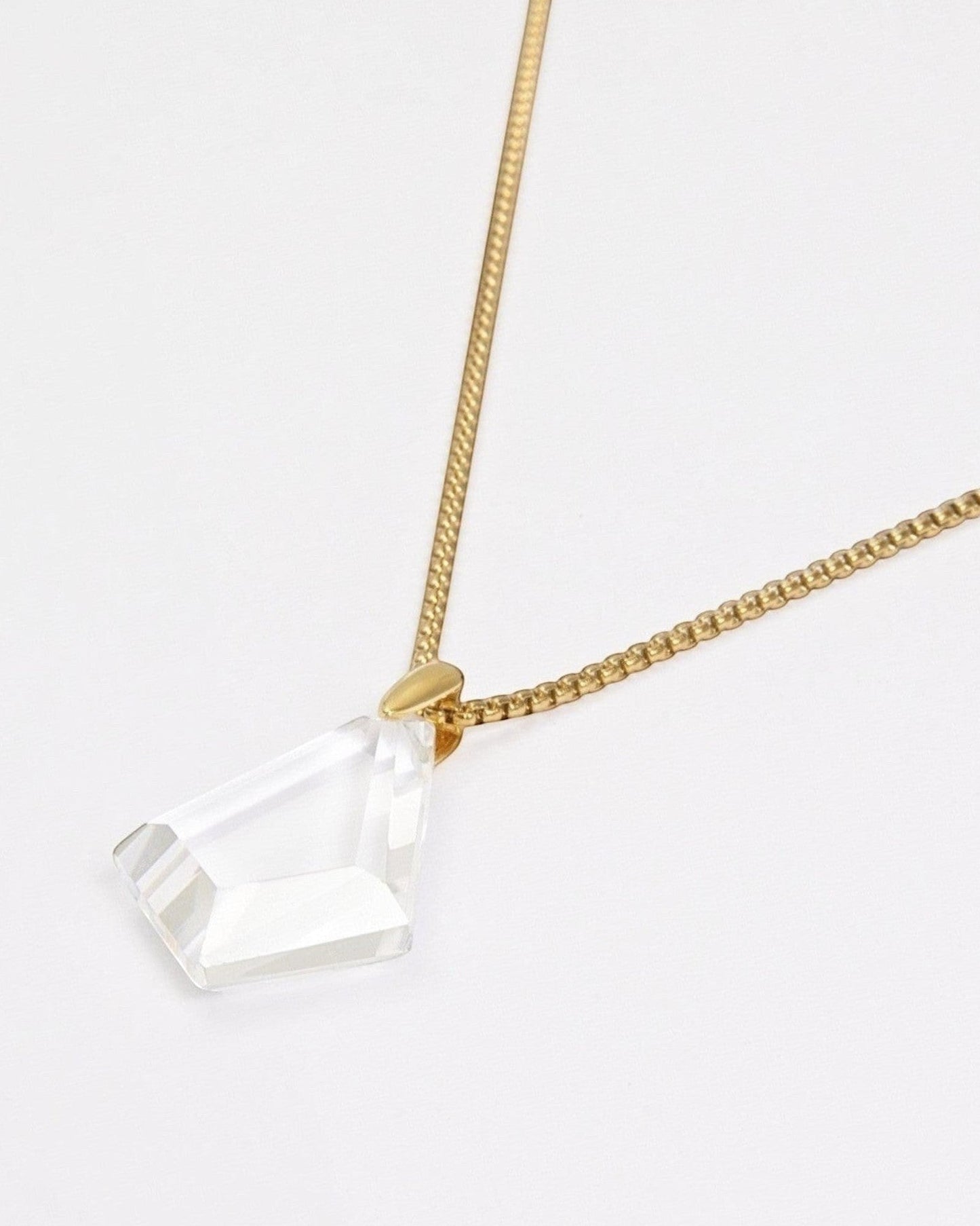 Elsita Jewelry Lustre III necklace featuring a faceted clear quartz pendant on a gold-tone stainless steel chain.