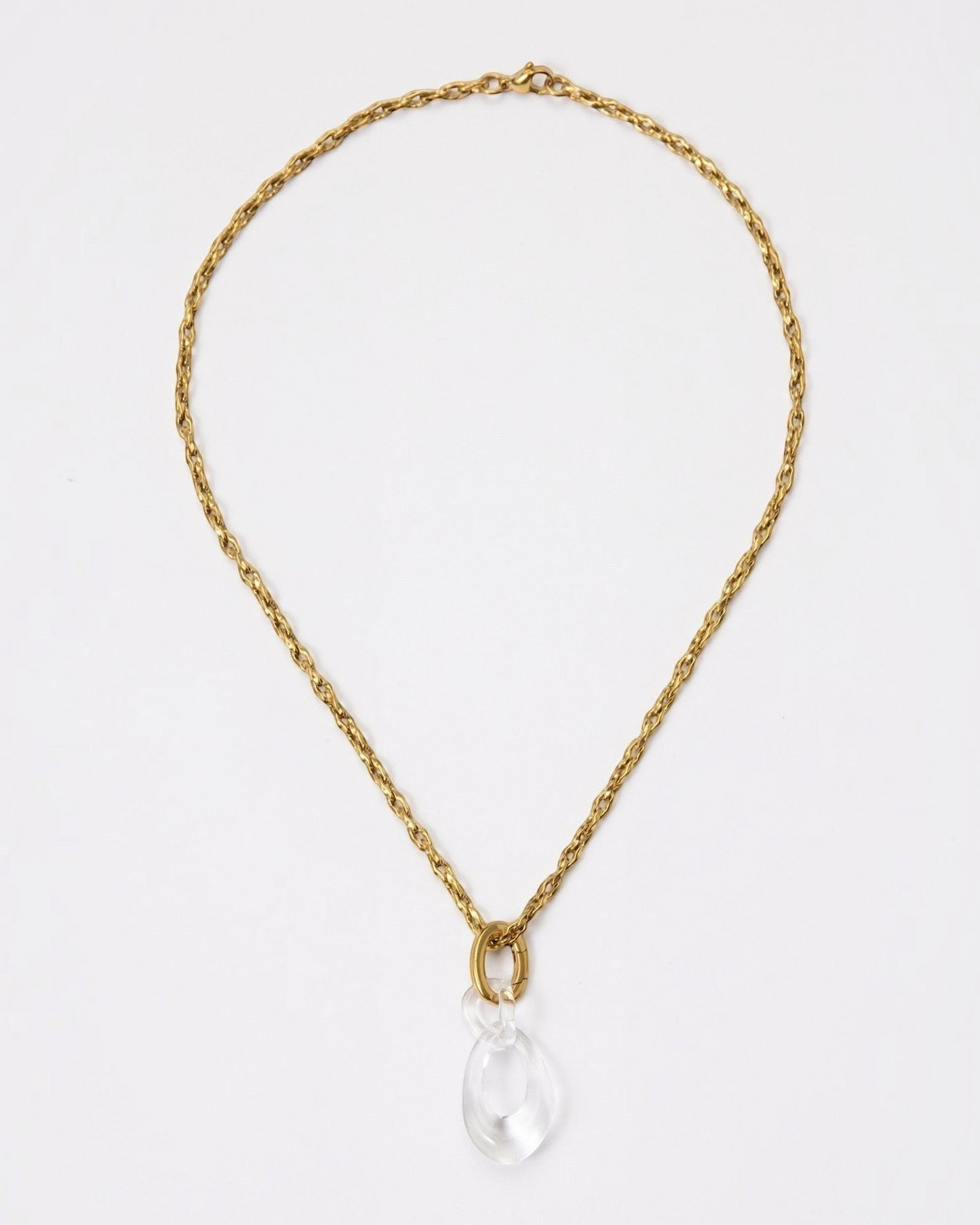 Elsita Jewelry Link Clear necklace featuring a hand-carved clear quartz interlocked chain pendant on a gold chain.