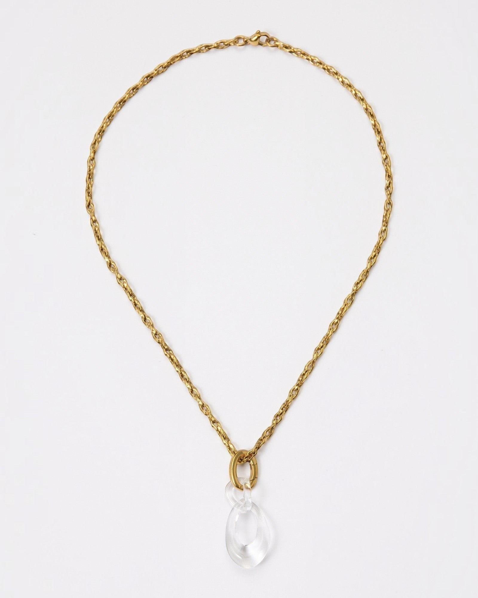 Elsita Jewelry Link Clear necklace featuring a hand-carved clear quartz interlocked chain pendant on a gold chain.