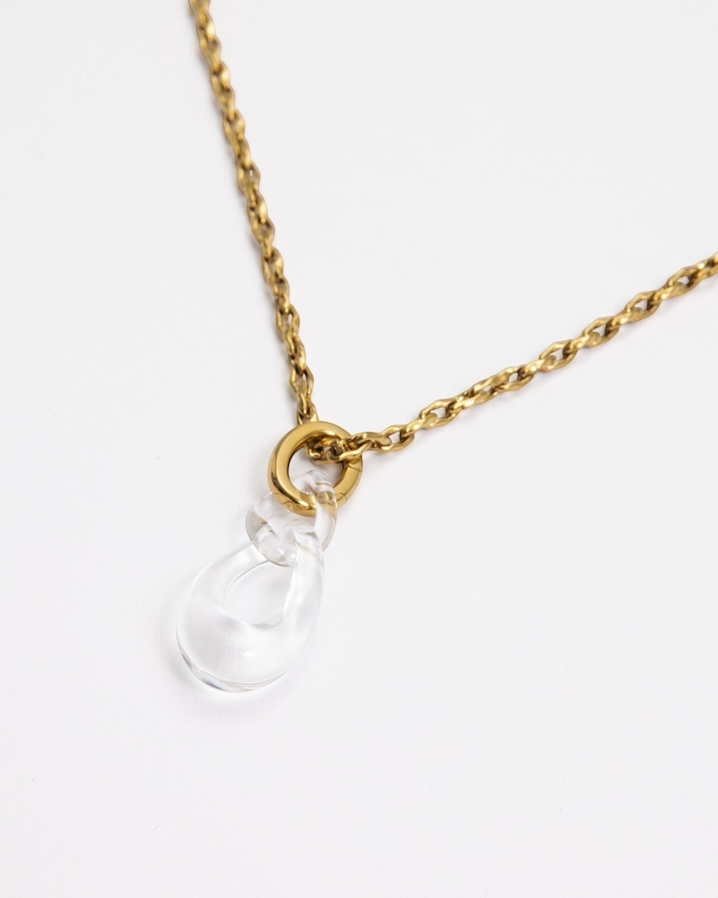 Elsita Jewelry Link Clear necklace featuring a hand-carved clear quartz interlocked chain pendant on a gold-tone chain.