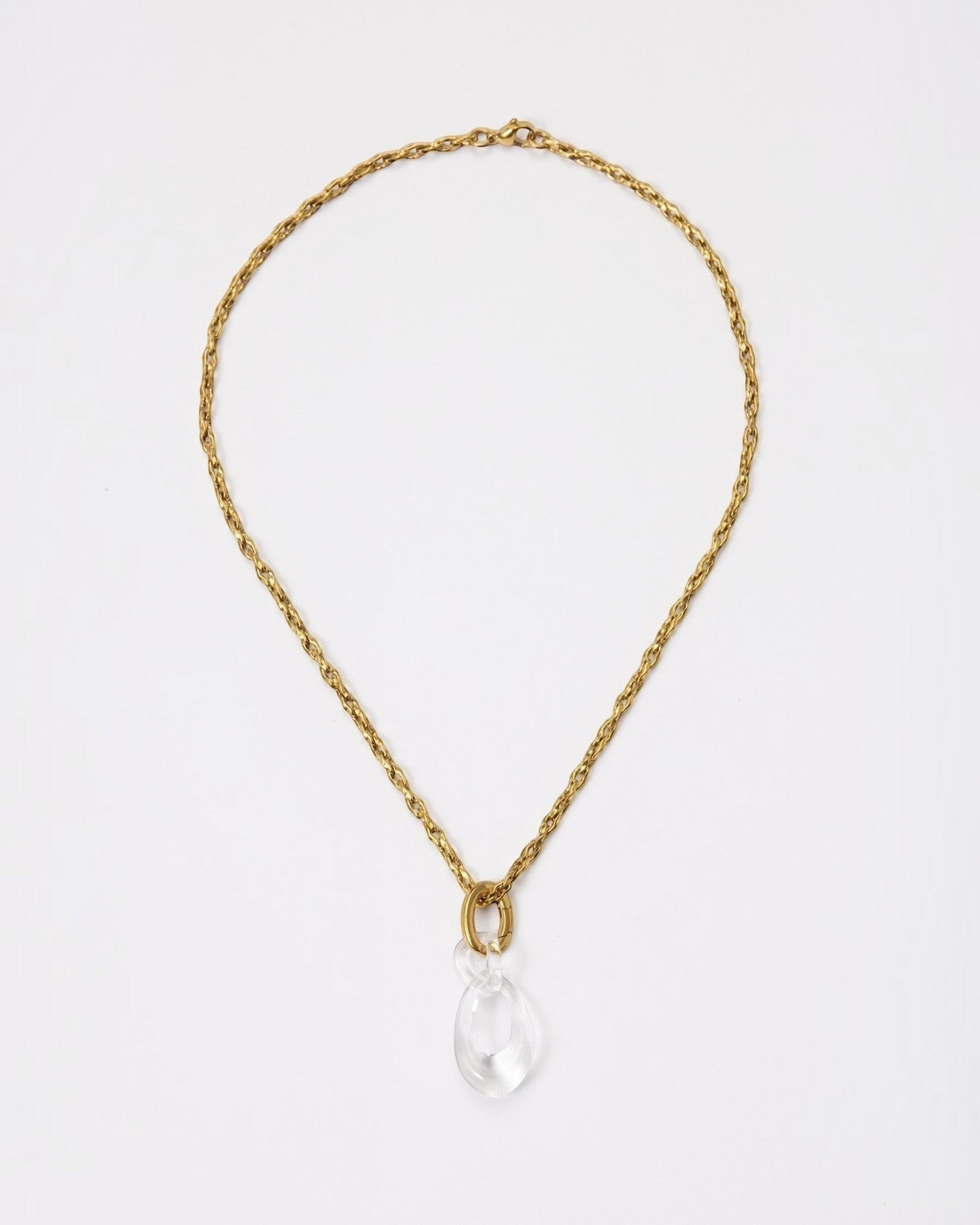 Elsita Jewelry Link Clear necklace featuring a hand-carved clear quartz interlocked chain pendant on a gold chain.