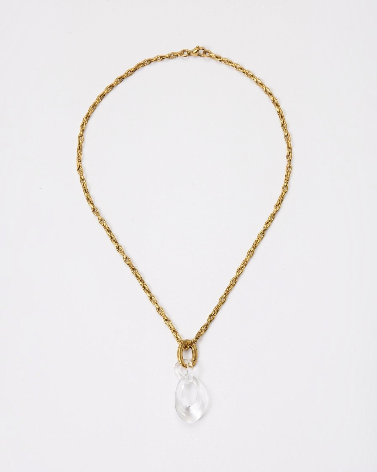 Elsita Jewelry Link Clear necklace featuring a hand-carved clear quartz interlocked chain pendant on a gold chain.
