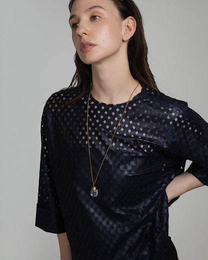 Elsita Jewelry Lustre IV necklace featuring a clear quartz pendant with gold-toned stainless steel on a long chain.
