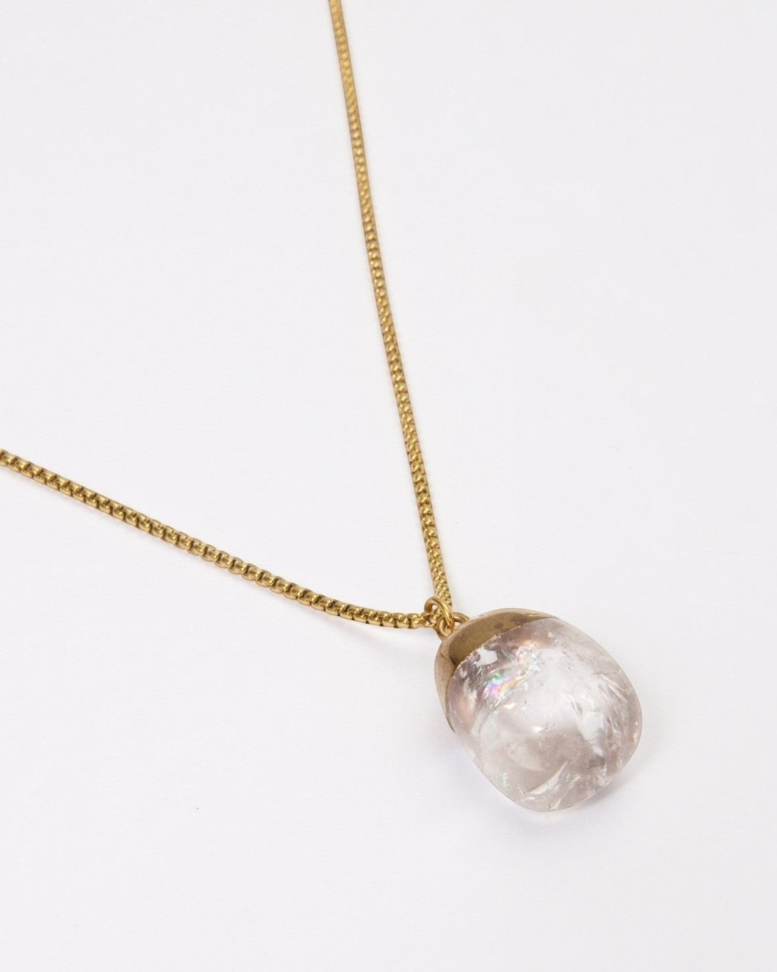Elsita Jewelry Lustre IV clear quartz pendant necklace on a gold-toned stainless steel chain against a white background
