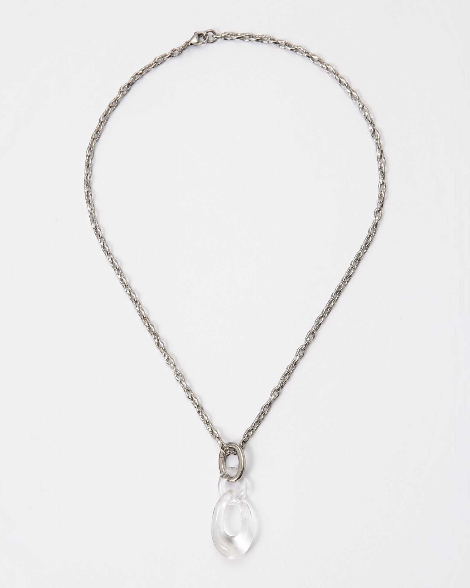 Elsita Jewelry Link Clear necklace featuring a hand-carved clear quartz interlocked chain pendant on a silver-tone chain.