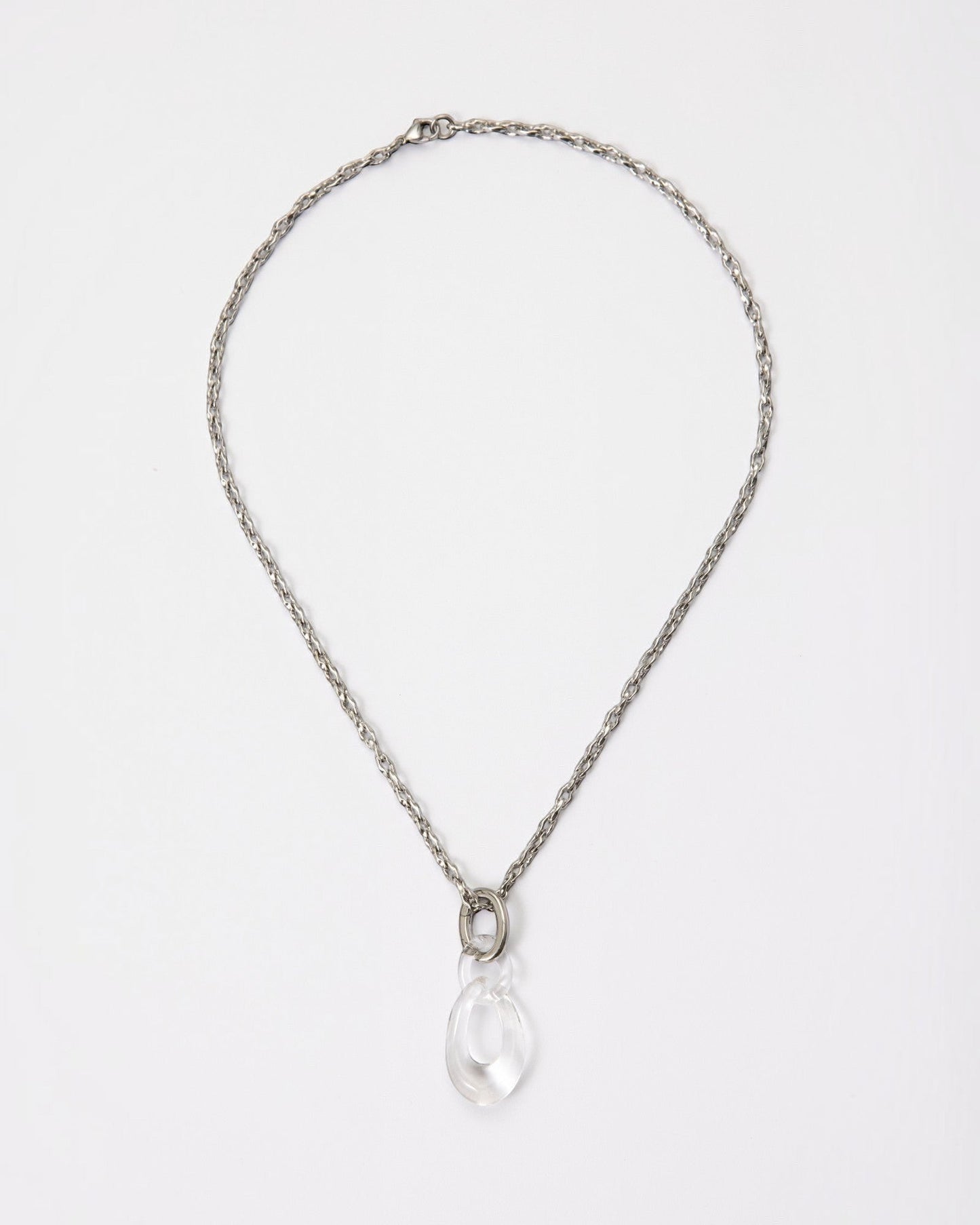 Elsita Jewelry Link Clear necklace featuring a hand-carved clear quartz interlocked chain pendant on a silver-tone chain.