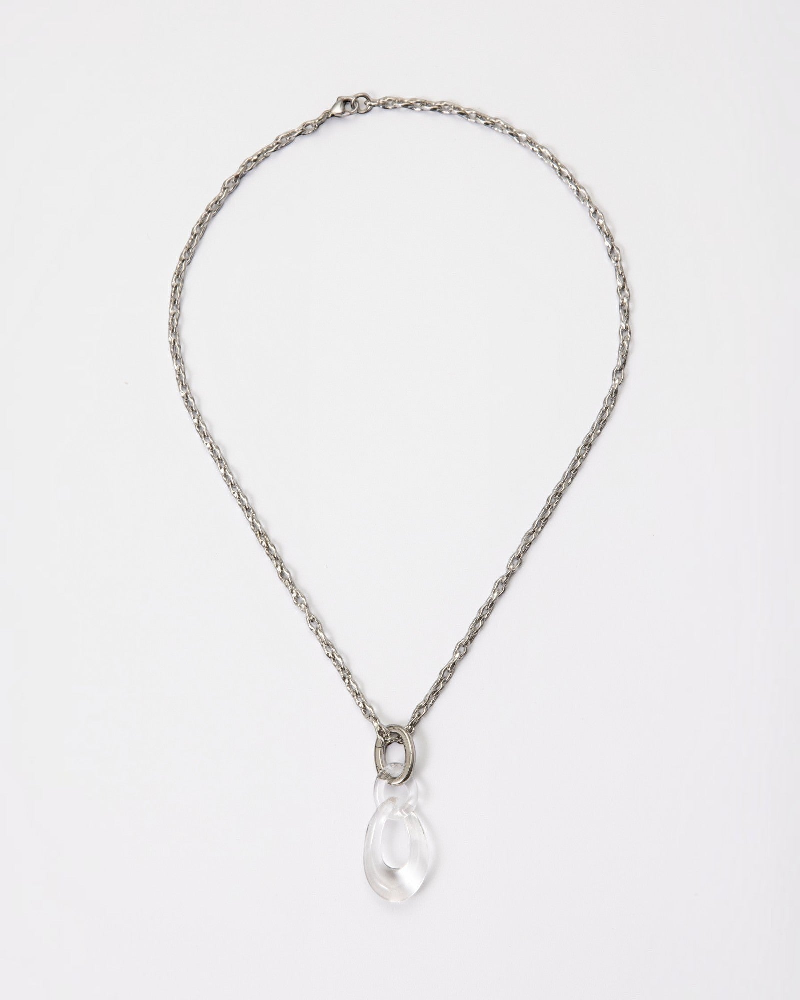 Elsita Jewelry Link Clear necklace featuring a hand-carved clear quartz interlocked chain pendant on a silver-tone chain.